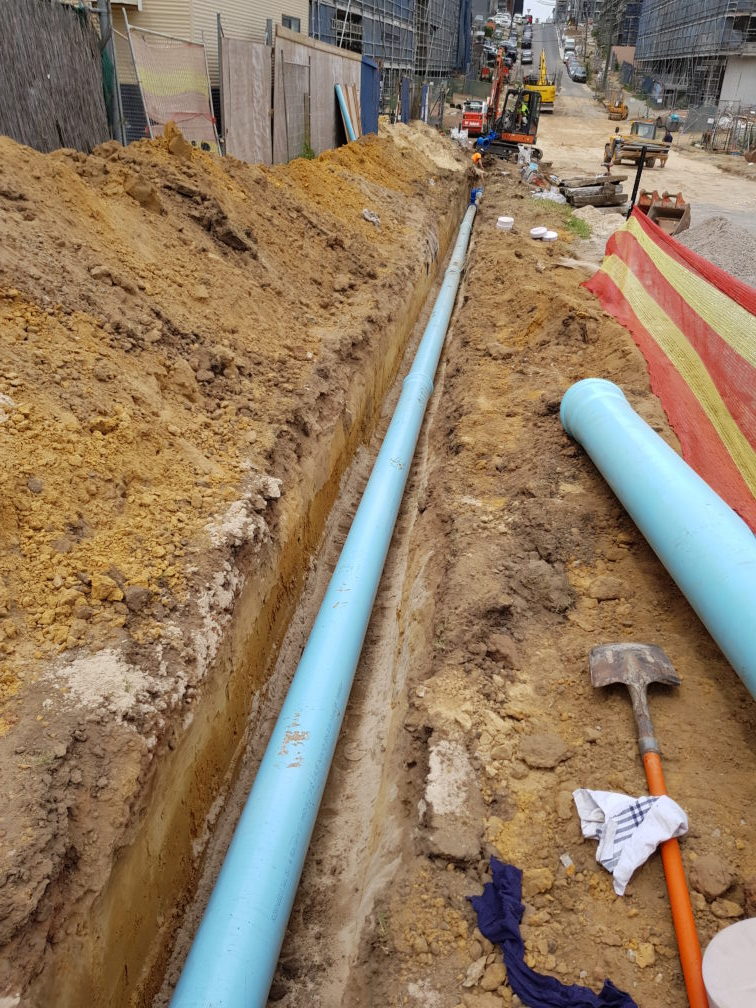 Watermain construction in busy site.